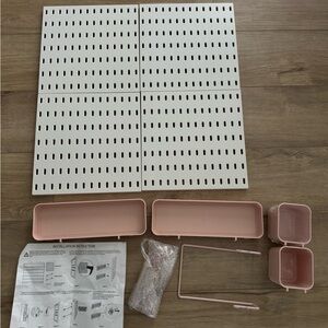 White Pegboard Organizer with Pink Bins